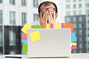 startup founder overwhelmed in front of his laptop